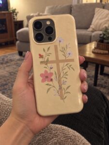 Floral cross phone over black denim